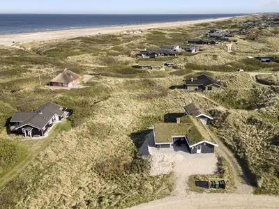 an aerial view of homes on the beach at Holiday Home Solvejg - 150m from the sea by Interhome in Løkken