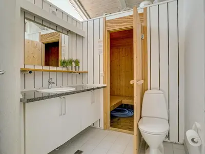 a bathroom with a toilet and a sink at Holiday Home Gorica - 450m from the sea by Interhome in Løkken
