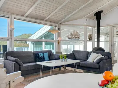 a living room with two couches and a table at Holiday Home Gorica - 450m from the sea by Interhome in Løkken