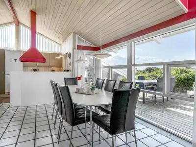 a kitchen and dining room with a table and chairs at Holiday Home Anne - 100m from the sea by Interhome in Løkken