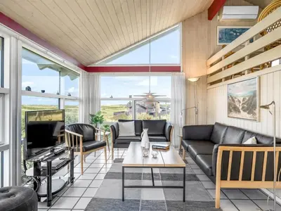 a living room with a couch and a table at Holiday Home Anne - 100m from the sea by Interhome in Løkken