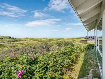 a view from the porch of a house with flowers at Holiday Home Anne - 100m from the sea by Interhome in Løkken