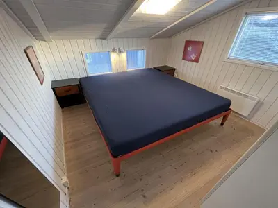 a small room with a bed and a desk at Holiday Home Avni - 200m from the sea by Interhome in Løkken
