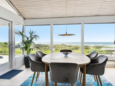 a dining room with a table and chairs at Holiday Home Alyssa - 300m from the sea by Interhome in Løkken
