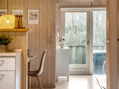 a kitchen with a door leading to a balcony at Holiday Home Seda - 600m from the sea by Interhome in Løkken