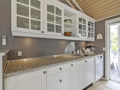 a kitchen with white cabinets and a sink at Holiday Home Jens - 425m from the sea by Interhome in Løkken