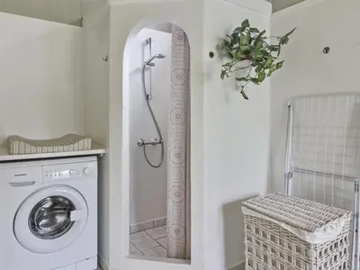 a bathroom with a shower and a washing machine at Holiday Home Jens - 425m from the sea by Interhome in Løkken