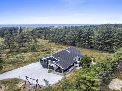 an overhead view of a house on a hill with trees at Holiday Home Jens - 425m from the sea by Interhome in Løkken