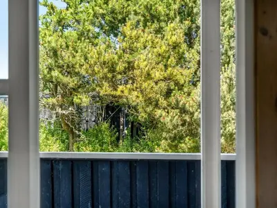 an open window with a view of a tree at Holiday Home Guja - 1km from the sea by Interhome in Løkken