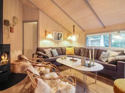 a living room with a couch and a table at Holiday Home Lovisa - 500m from the sea by Interhome in Løkken