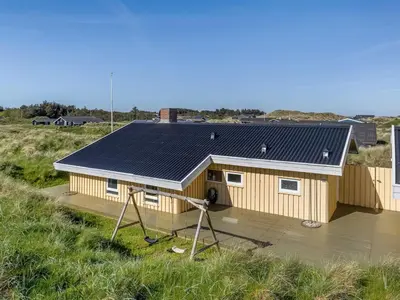a house with solar panels on the roof at Holiday Home Estefania - 450m from the sea by Interhome in Løkken
