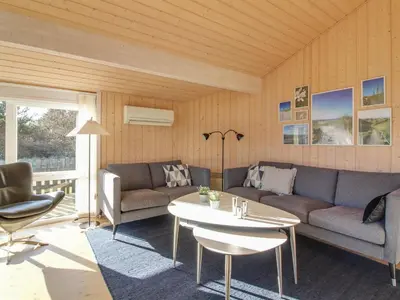 a living room with a couch and a table at Holiday Home Nynke - 600m from the sea by Interhome in Løkken