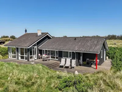 a house with a deck on the beach at Holiday Home Lauri - 350m from the sea by Interhome in Løkken