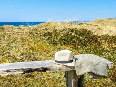 a hat sitting on a bench near the beach at Holiday Home Ingela - 350m from the sea by Interhome in Løkken