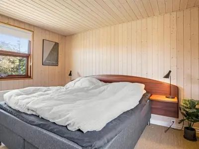 a bedroom with a large bed in a room at Holiday Home Ingela - 350m from the sea by Interhome in Løkken