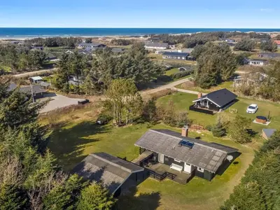an aerial view of a house with a view of the ocean at Holiday Home Conradine - 500m from the sea by Interhome in Løkken