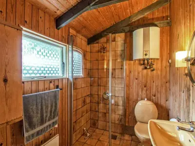 a bathroom with a shower and a toilet and a sink at Holiday Home Conradine - 500m from the sea by Interhome in Løkken
