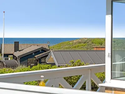 a view of the ocean from the balcony of a house at Holiday Home Mielikki - 200m from the sea by Interhome in Løkken