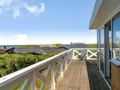 a deck with a view of the ocean at Holiday Home Mielikki - 200m from the sea by Interhome in Løkken