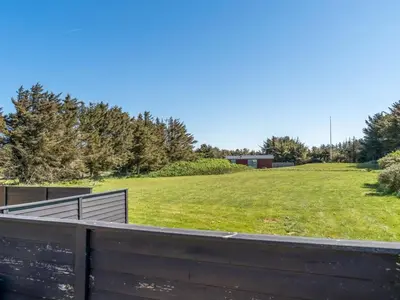 a field of grass with a fence and a field at Holiday Home Nayeli - 275m from the sea by Interhome in Løkken