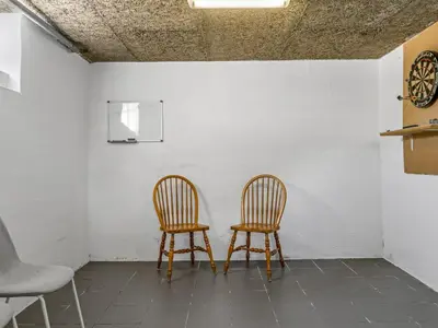 two chairs sitting next to a wall with a clock at Holiday Home Nayeli - 275m from the sea by Interhome in Løkken