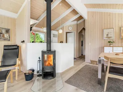 a fireplace in the living room of a house at Holiday Home Elvan - 450m from the sea by Interhome in Løkken