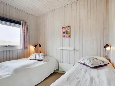 a bedroom with two beds and a window at Holiday Home Elco - 450m from the sea by Interhome in Løkken