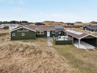 a house with solar panels on top of a field at Holiday Home Elco - 450m from the sea by Interhome in Løkken