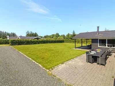 a backyard with a picnic table and a house at Holiday Home Susan - 600m from the sea by Interhome in Løkken