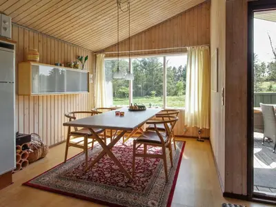 a dining room with a table and chairs at Holiday Home Taina - 1-1km from the sea by Interhome in Løkken