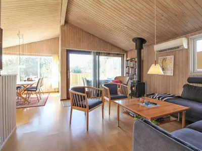a living room with a couch and a table at Holiday Home Taina - 1-1km from the sea by Interhome in Løkken