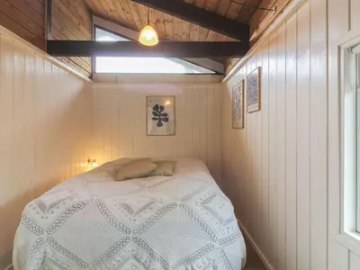 a bedroom with a bed in a small room at Holiday Home Eyer - 800m from the sea by Interhome in Løkken