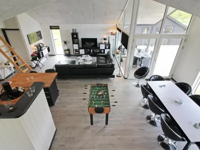 a living room with a table in the middle of a room at Holiday Home Aldina - 1-5km from the sea by Interhome in Løkken