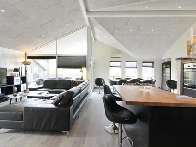 a living room with a couch and a table at Holiday Home Aldina - 1-5km from the sea by Interhome in Løkken