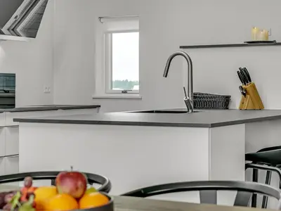 a kitchen with a sink and a bowl of fruit at Holiday Home Fegge - 1-5km from the sea by Interhome in Løkken