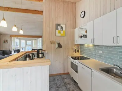 a kitchen with white cabinets and a sink at Holiday Home Sonke - 500m from the sea by Interhome in Løkken