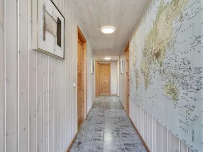 a hallway with a map of the world on the wall at Holiday Home Sonke - 500m from the sea by Interhome in Løkken