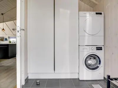 a washer and dryer in a room with a kitchen at Holiday Home Ina - 1-2km from the sea by Interhome in Løkken