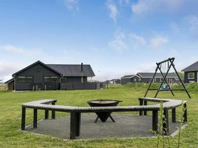 a park with a playground and a swing at Holiday Home Ina - 1-2km from the sea by Interhome in Løkken