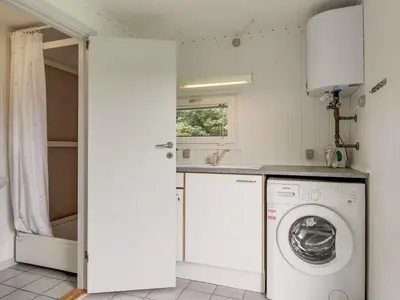 a laundry room with a washer and dryer at Holiday Home Gitten - 600m from the sea by Interhome in Løkken