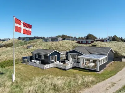 a house on the beach with a canadian flag at Holiday Home Ecaterina - 100m from the sea by Interhome in Løkken