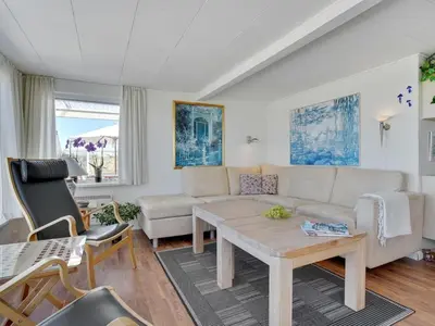 a living room with a couch and a table at Holiday Home Ecaterina - 100m from the sea by Interhome in Løkken