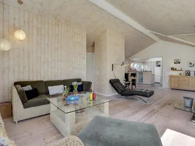 a living room with a couch and a table at Holiday Home Herwarth - 3-3km from the sea by Interhome in Blokhus
