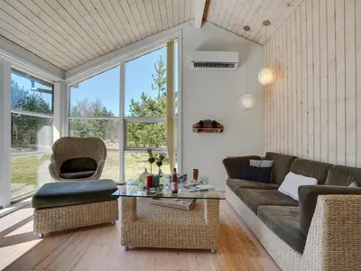 a living room with a couch and a table at Holiday Home Herwarth - 3-3km from the sea by Interhome in Blokhus