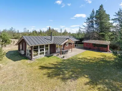 a home with a large yard and a barn at Holiday Home Herwarth - 3-3km from the sea by Interhome in Blokhus