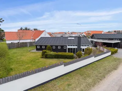 a black house with a black roof at Holiday Home Frethi - 350m from the sea by Interhome in Blokhus