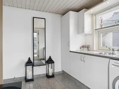 a kitchen with two lights and a mirror at Holiday Home Frethi - 350m from the sea by Interhome in Blokhus