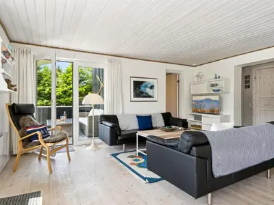 a living room with a couch and a table at Holiday Home Marli - 700m from the sea by Interhome in Blokhus