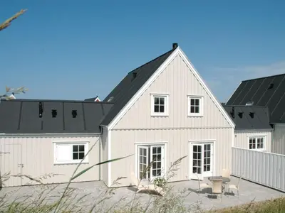 a large white house with a black roof at Holiday Home Ønef - 1km from the sea by Interhome in Blokhus