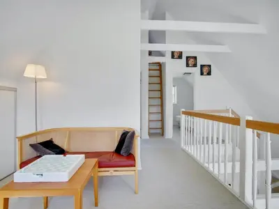 a living room with a couch and a table at Holiday Home Ønef - 1km from the sea by Interhome in Blokhus